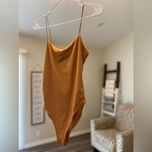 Tan orange woman bodysuit. Size M . Brand new never worn